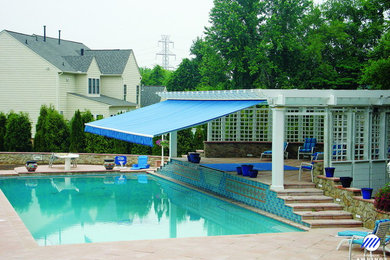 Minimalist brick and rectangular aboveground pool photo in Baltimore