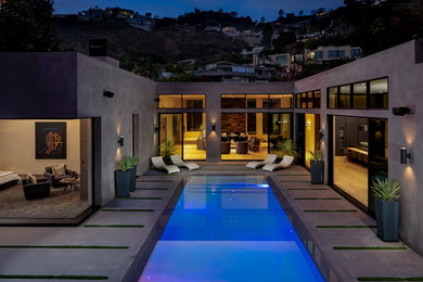 Inspiration for a mid-sized modern backyard tile and rectangular natural hot tub remodel in Los Angeles