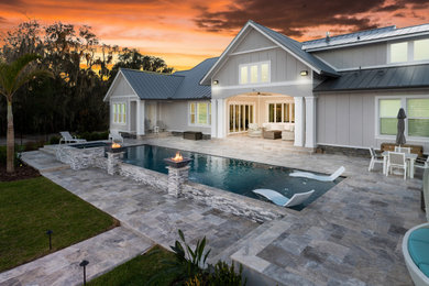 Pool house - large coastal backyard stone and rectangular natural pool house idea in Tampa