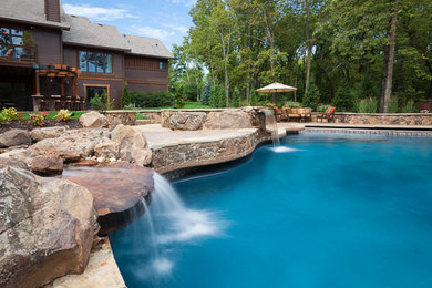 Pool fountain - large backyard custom-shaped pool fountain idea in Kansas City
