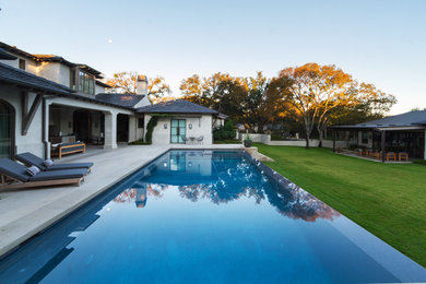 Pool house - large mediterranean backyard concrete paver and rectangular lap pool house idea in Austin