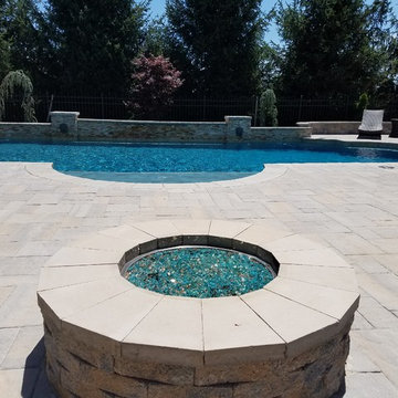 Roman Style Pool with raised wall, fire pit & outdoor kitchen