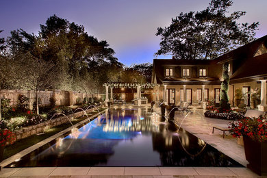Diseño de piscina alargada clásica grande rectangular en patio con suelo de hormigón estampado