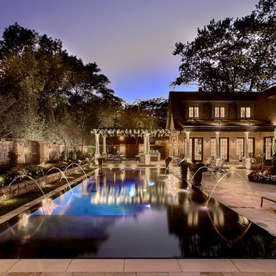 Pool - large traditional courtyard rectangular and stamped concrete lap pool idea in Chicago
