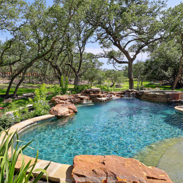 Rustic freeform with Boulder Wall Waterfalls and Spa