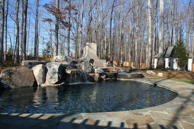 Example of a mid-sized mountain style backyard custom-shaped natural pool fountain design in Raleigh