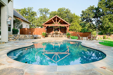 Inspiration for a large timeless backyard stone natural pool house remodel in Dallas