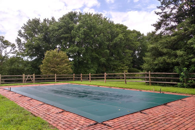 Pool - mid-sized backyard brick and rectangular lap pool idea in Wilmington