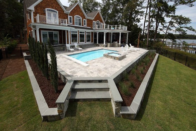 Mid-sized tuscan backyard stone and rectangular pool photo in Wilmington