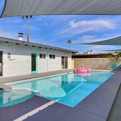 Example of a large mid-century modern backyard concrete and rectangular lap hot tub design in Phoenix