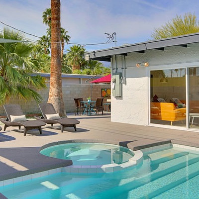 Inspiration for a large mid-century modern backyard concrete and rectangular lap hot tub remodel in Los Angeles