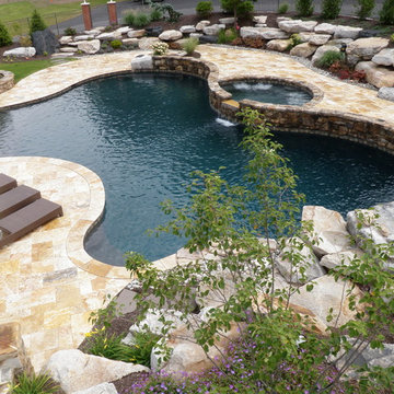 Schuylkill County custom pool with raised spa, waterfall, & sunshelf