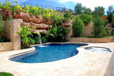 Island style pool photo in Orange County