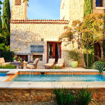 Hot tub - mid-sized mediterranean backyard rectangular lap hot tub idea in Orange County