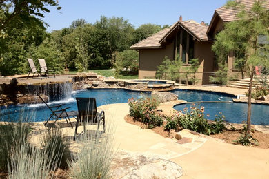 Inspiration for a large timeless backyard stone and custom-shaped natural hot tub remodel in Kansas City