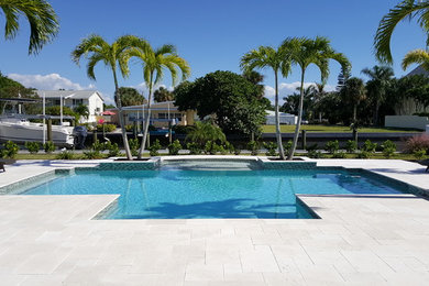 Diseño de casa de la piscina y piscina natural contemporánea grande a medida en patio trasero con adoquines de piedra natural