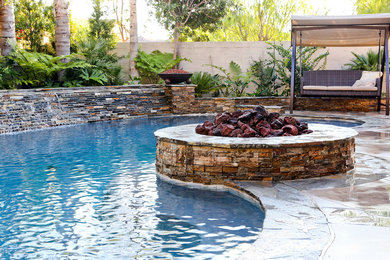 Pool fountain - mid-sized traditional backyard concrete and kidney-shaped lap pool fountain idea in Orange County