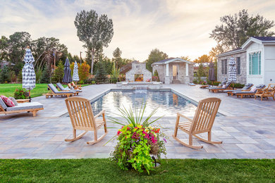 Large elegant backyard concrete paver and rectangular hot tub photo in Salt Lake City