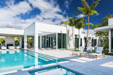 Example of a trendy backyard rectangular hot tub design in Miami