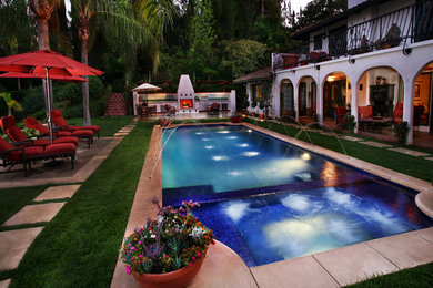 Pool fountain - mid-sized mediterranean backyard concrete and custom-shaped lap pool fountain idea in Los Angeles