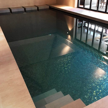 Small modern indoor pool with custom mosaic mix