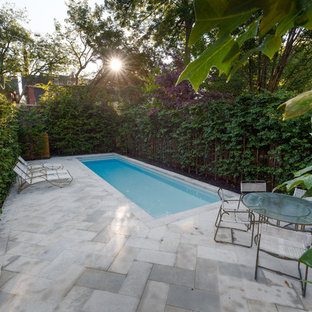 Inspiration for a small traditional backyard rectangular pool in Toronto with natural stone pavers.