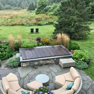 Inspiration for a small traditional backyard rectangular natural pool in Boston with a hot tub and natural stone pavers.