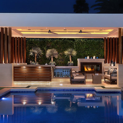 Example of a large trendy backyard stone and rectangular pool design in Orange County