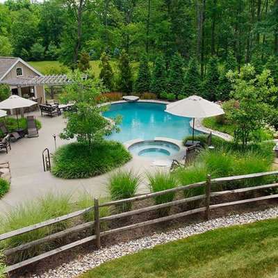 Example of a classic backyard custom-shaped pool design in Philadelphia