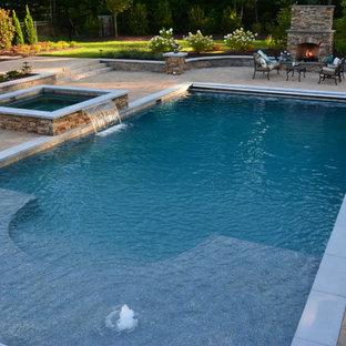 Photo of a large arts and crafts backyard rectangular lap pool in Richmond with a hot tub and concrete pavers.