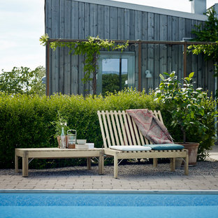 Inspiration for a mid-sized scandinavian rectangular aboveground pool in Berlin with brick pavers.
