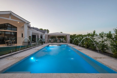 Example of a transitional backyard rectangular pool design in Phoenix