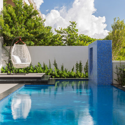 Pool fountain - mid-sized contemporary backyard rectangular lap pool fountain idea in Miami