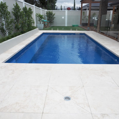 Pool landscaping - mid-sized modern backyard stone and rectangular natural pool landscaping idea in Melbourne