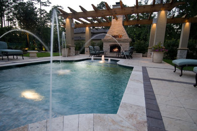 Example of a small classic backyard stone and custom-shaped pool design in Houston