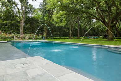 Example of a classic backyard stone and custom-shaped pool design in Houston