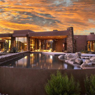 Mid-sized southwest backyard custom-shaped and concrete paver natural pool photo in Phoenix