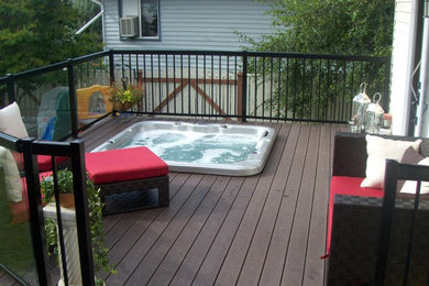 Elegant backyard concrete hot tub photo in Calgary