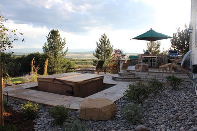 Example of a mid-sized classic backyard gravel hot tub design in Denver