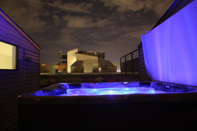 Example of a mid-sized classic backyard gravel hot tub design in Denver
