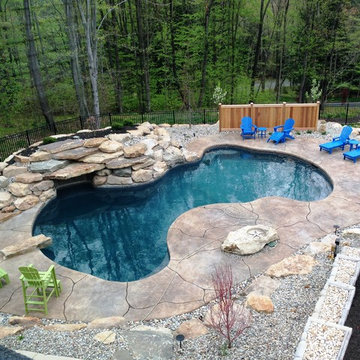 Spring Brook Township custom pool with boulders and waterfall