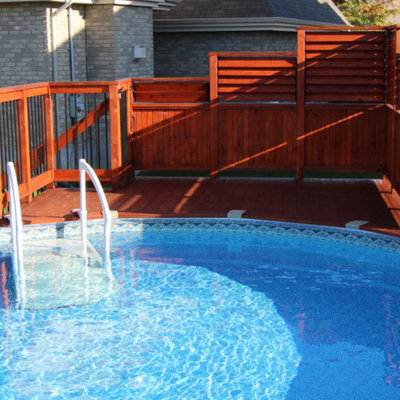 Example of a mid-sized arts and crafts backyard round aboveground pool design in Montreal