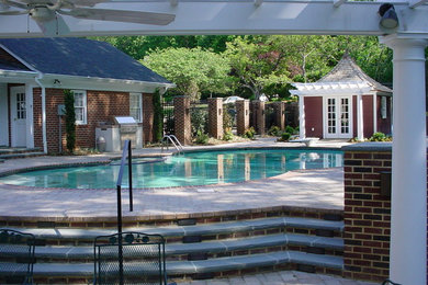 Example of a large classic backyard brick and kidney-shaped natural pool house design in DC Metro