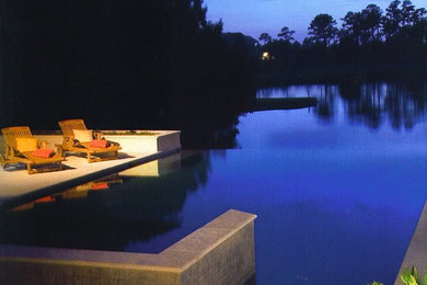 Inspiration for a timeless backyard rectangular infinity pool remodel in Other