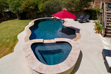 Inspiration for a mid-sized timeless backyard concrete and custom-shaped pool remodel in Austin