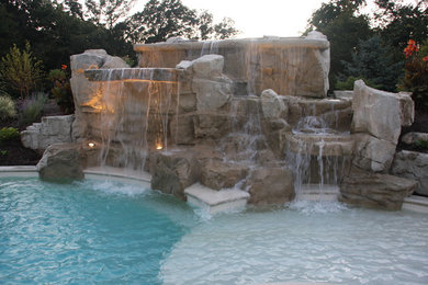 Inspiration for a mid-sized coastal backyard stamped concrete and custom-shaped natural pool fountain remodel in Chicago
