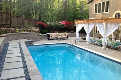 Inspiration for a large timeless backyard concrete paver and rectangular lap pool remodel in DC Metro