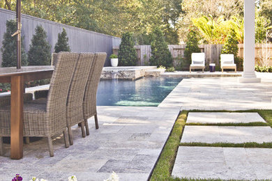 Design ideas for a small modern back custom shaped hot tub in Houston with natural stone paving.