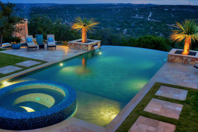 Hot tub - tropical backyard tile infinity hot tub idea in Austin