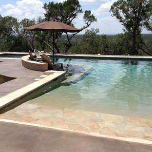 Large minimalist backyard custom-shaped lap hot tub photo in Austin with decking
